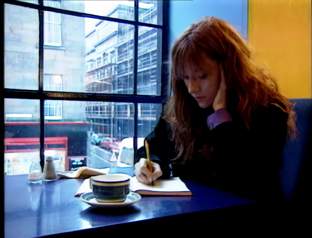 J.K. Rowling writing in a cafe